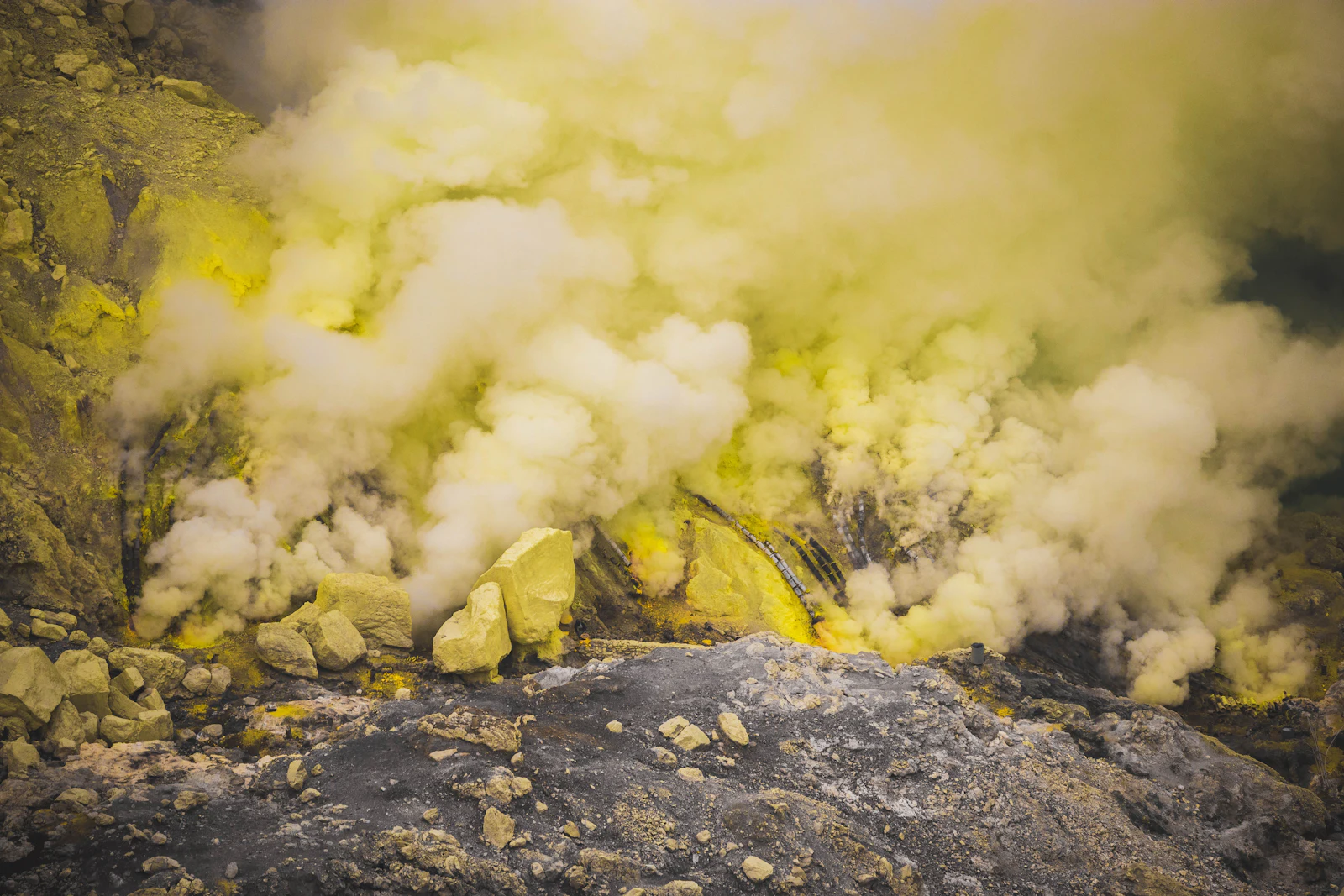 Yellow sulphur deposits and vapour at a natural source